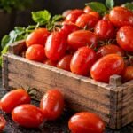 Fresh red grape tomatoes arranged in a rustic wooden crate